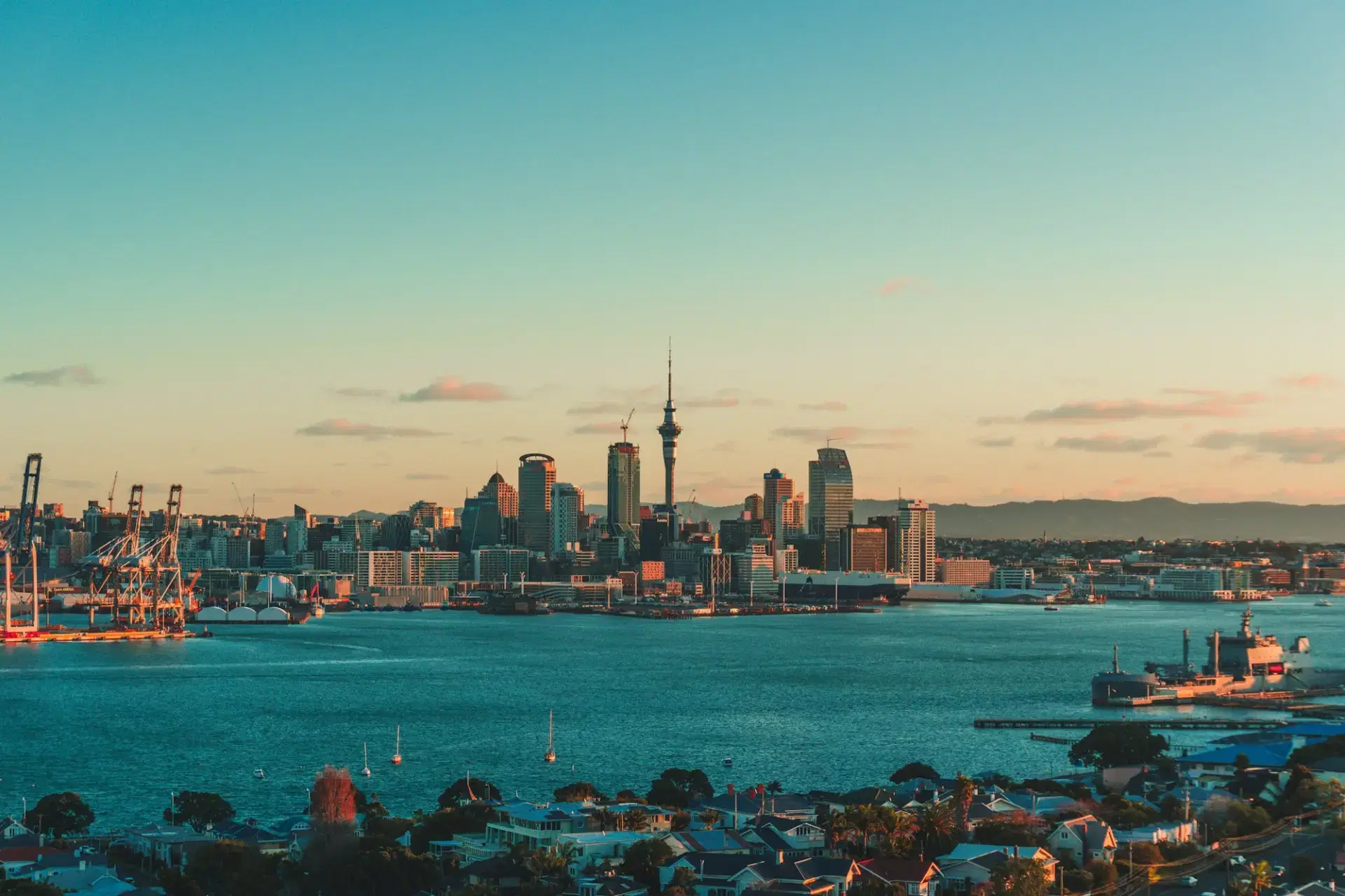 Auckland skyline and harbour under a warm low sun