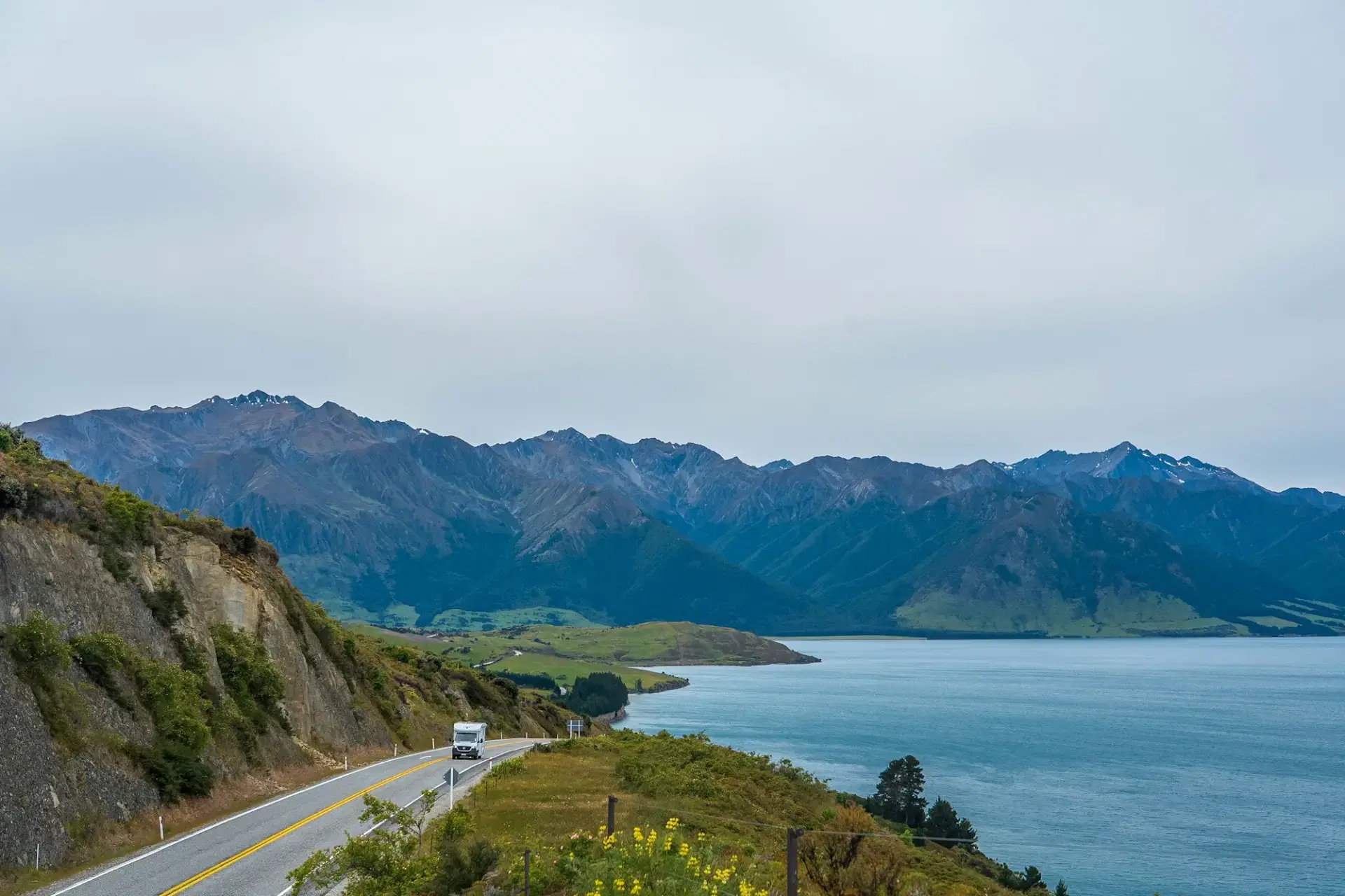 Scenic road beside a lake and mountains